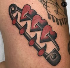 a close up of a person's leg with an arrow and hearts on it