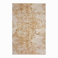 a beige and gold rug with an intricate design on the bottom, in front of a white background