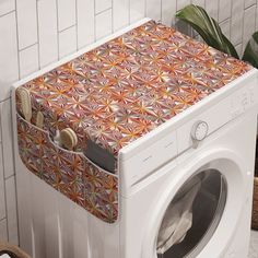 a white washer sitting next to a tiled wall