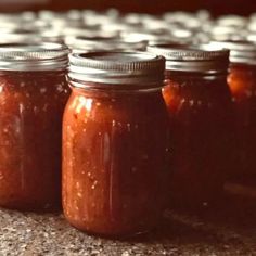 several jars filled with food sitting on top of a counter