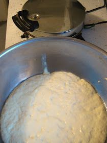 a ball of dough in a metal bowl