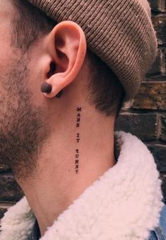 a man with a tattoo on his ear