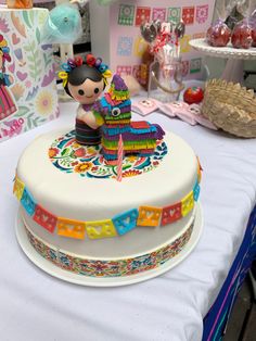 a decorated cake sitting on top of a table next to other desserts and decorations