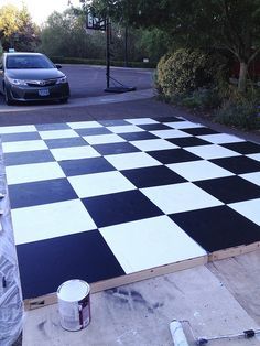 a black and white checkered floor is being painted