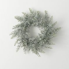 a white wreath with snow on it