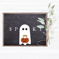 a blackboard with a ghost and pumpkin on it