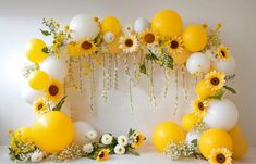 an arrangement of balloons and flowers are arranged in the shape of a circle