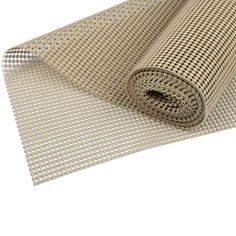 a roll of beige and white checkered fabric on top of a white floor mat