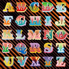 the letters are made up of different colors and shapes, including one letter in the upper left corner