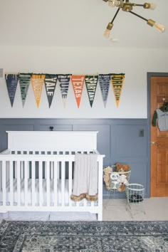 a baby's room decorated with pennants and toys