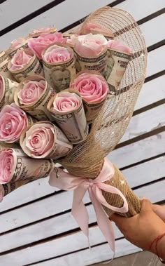 a bouquet of pink roses wrapped in twine