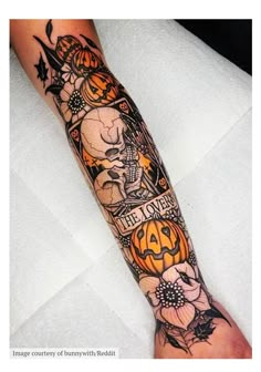 a person with a tattoo on their arm that has pumpkins and flowers all over it