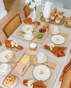 the table is set with plates, silverware, and other items for an elegant dinner