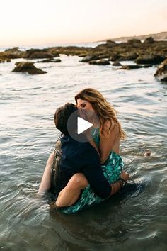 a man and woman are sitting in the water