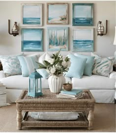 a living room filled with furniture and paintings on the wall above it's coffee table