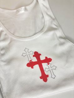 Details PREORDER- will be shipped within next two weeks! CUSTOM / HANDMADE Ribbed white tank top with custom hand painted cross and overlapping rhinestone cross embellishments. 100% Cotton Hand wash in cold water to preserve crystal placement Size & Fit One size White Cross Back Tank Top For Summer, Fitted White Cross Back Tank Top, White Fitted Cross Back Tank Top, Crystal Placement, Hand Painted Crosses, Top Paintings, Cross Shirts, Crystal Cross, Rhinestone Cross