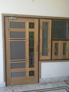 an open wooden door with glass panels on the side