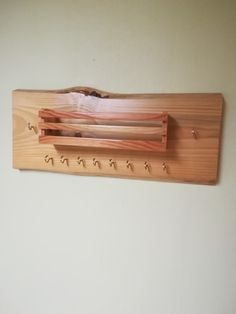 a wooden coat rack with hooks on the wall