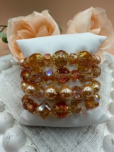 This is a beautiful eye catching four  bracelet set in shades of an orange sunset with gorgeous Czech focal beads, crystal cubes and pearls.  This bracelet set is perfect for any occasion dressed up or down.  You will get many compliments when wearing it.  This is a great gift idea for any occasion for your wife, Mom or daughter.  We are a new Etsy shop and appreciate you shopping with us.   Please feel free to reach out with any questions. Thanks, Susan Handmade Orange Beaded Bracelets For Party, Elegant Multi-strand Bracelets With Colorful Beads, Bohemian Orange Beaded Bracelets For Party, Orange Beaded Bracelets For Party, Stackable Orange Round Beaded Bracelets, Orange Stackable Bracelets With Round Beads, Elegant Rose Gold Jewelry With Colorful Beads, Orange Bangle Jewelry With Colorful Beads, Orange Multi-strand Jewelry Gift