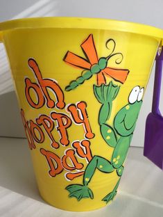 a yellow bucket with the words do happy days painted on it