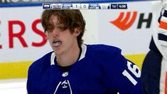 a hockey player with his mouth open in front of the goalie's net