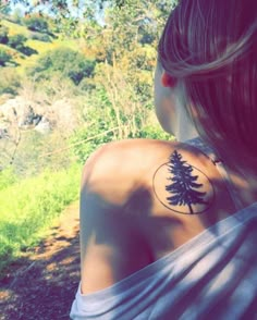 a woman with a tree tattoo on her back