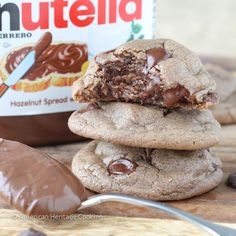 chocolate chip cookies stacked on top of each other next to a container of nutella