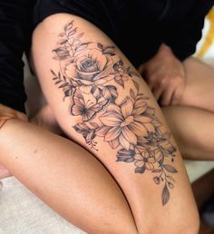 a woman's thigh with flowers on it