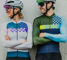 two people in cycling gear standing next to each other