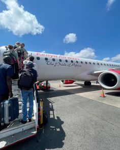 people getting off an airplane on the tarmac