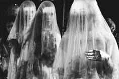 three brides with veils on their heads and hands