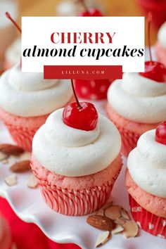 cherry almond cupcakes with white frosting and cherries on top, sitting on a plate