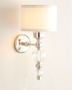 a wall light with a white shade on it