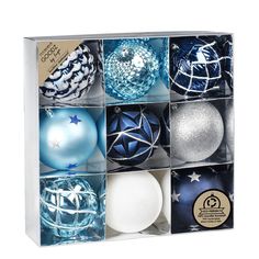 an assortment of blue and silver ornaments in a box