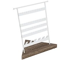 a white wooden display rack with four shelves on each side and one shelf attached to the wall