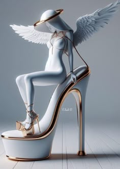 a high heeled shoe with an angel wing on the top and gold trimmings