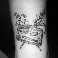 a black and white photo of a piece of bread on a table next to a plant