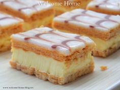 several pieces of cake on a plate with the words welcome home written in white letters