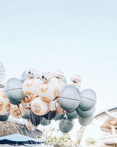 an assortment of balloons floating in the air