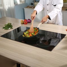 a chef is cooking vegetables on the stove