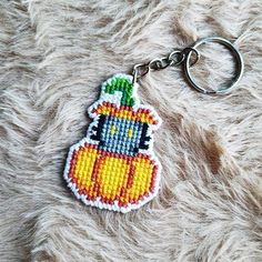 a cross stitch keychain with an image of a cartoon character on it