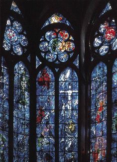 two large stained glass windows in a church