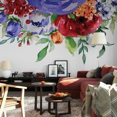 a living room with flowers painted on the wall