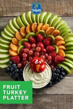 a fruit turkey platter with grapes, apples, kiwis and strawberries