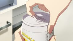 a person is opening up a can of soda