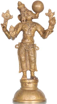 a golden statue with two hands holding a ball