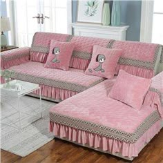 a living room filled with pink couches and pillows