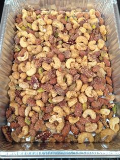 a plastic container filled with nuts sitting on top of a stove