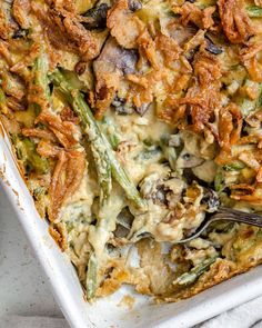 a casserole dish with asparagus, mushrooms and other toppings in it