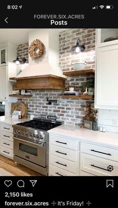 a kitchen with brick walls and white cabinets, an oven, stove top and microwave